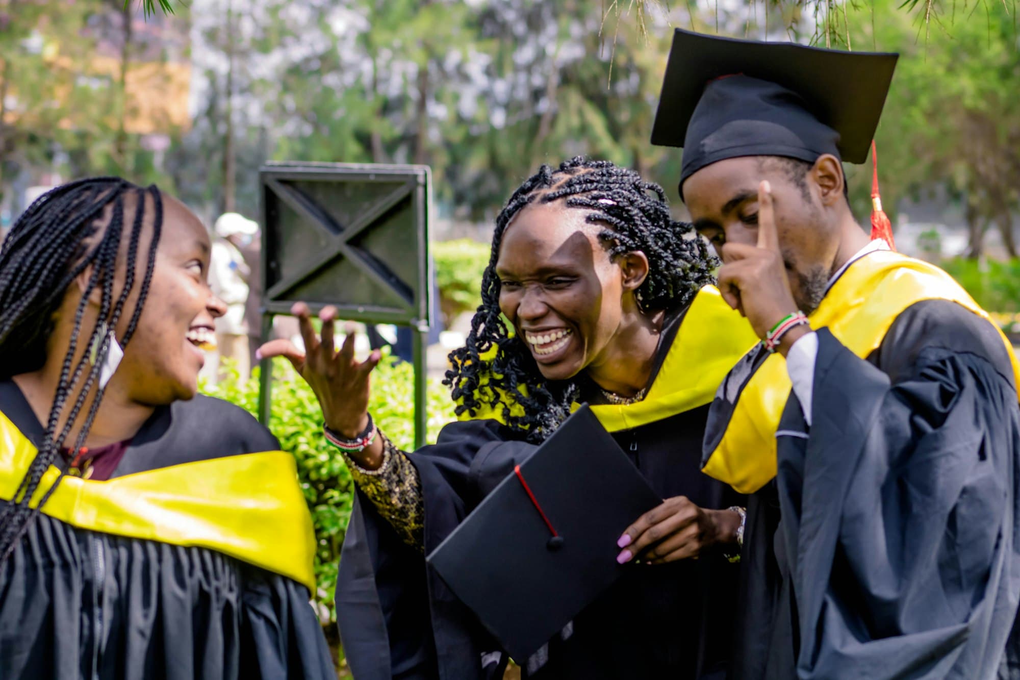 Students laughing together in academic gowns